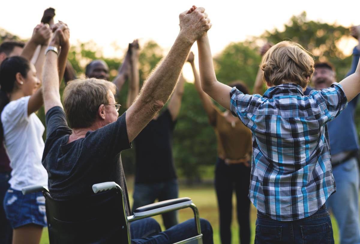 Group of people holding hands together